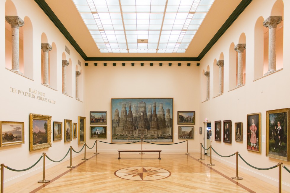 Gallery with paintings and archways.