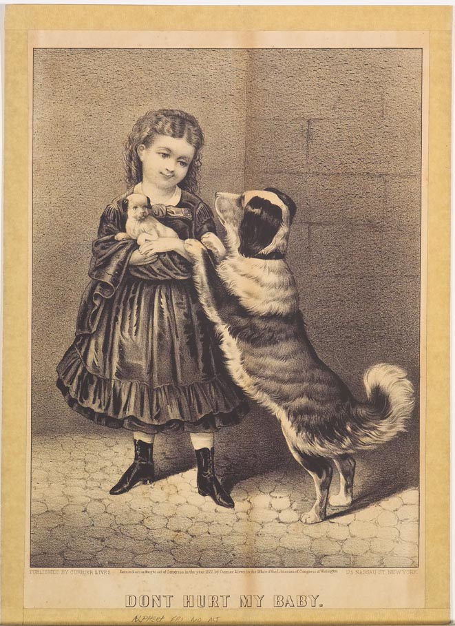 Young girl holding puppy standing at her left