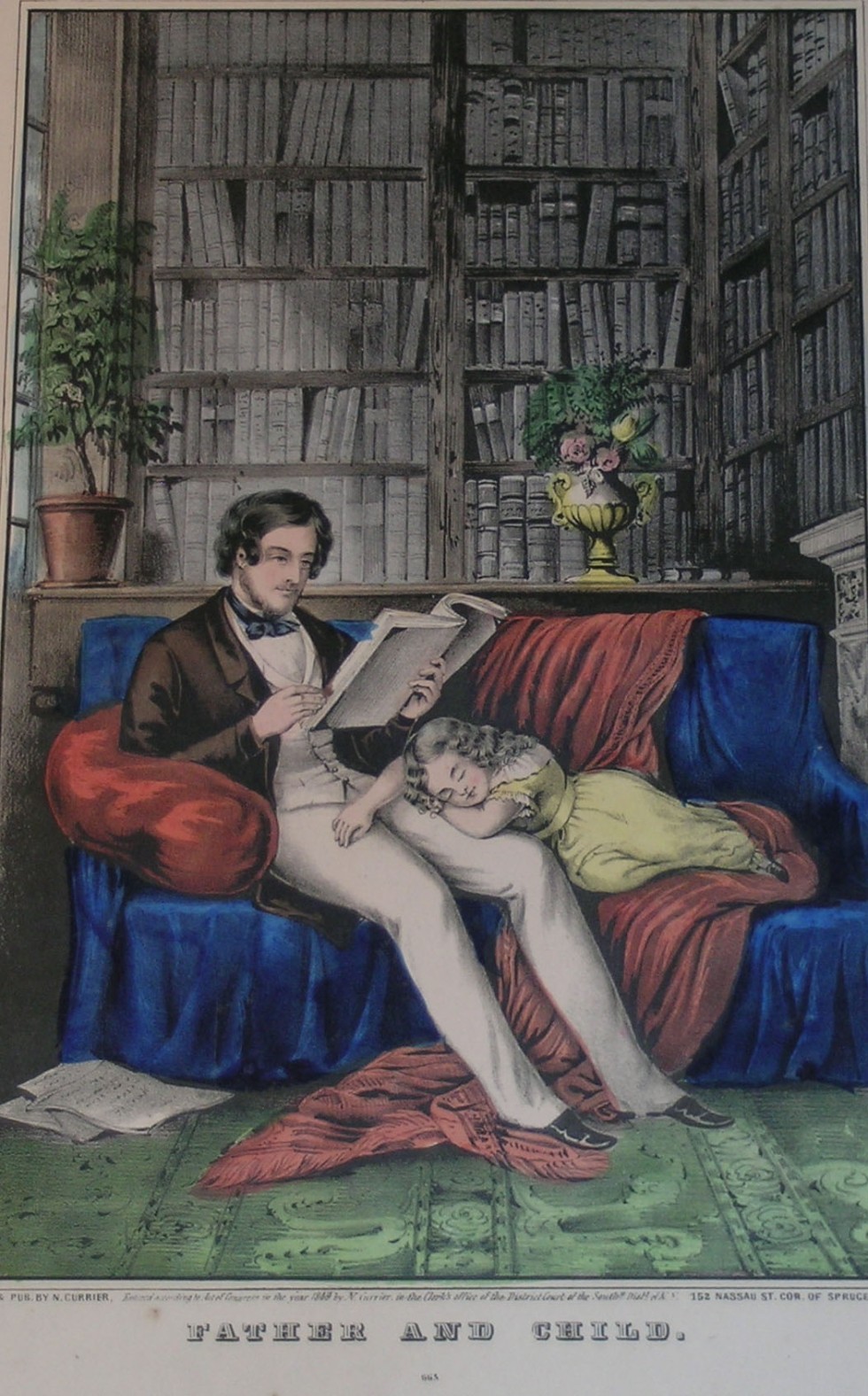 Interior of a study with father reading a book sitting on a couch and daughter fast asleep in his lap