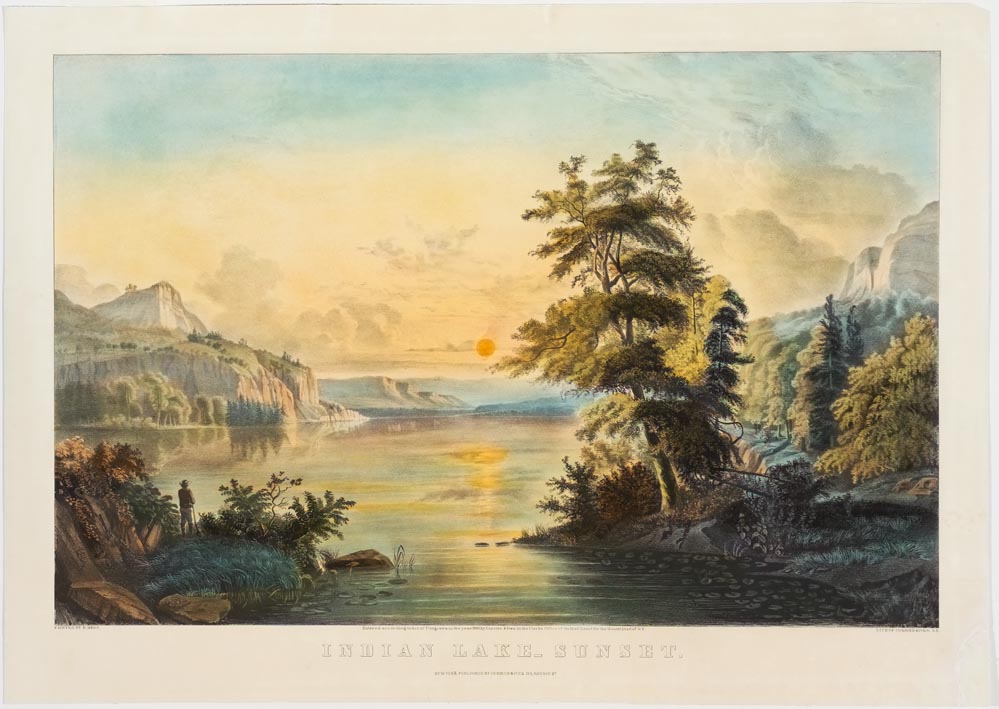 Hunter with rifle standing in lower left looking out over lake watching the sunset