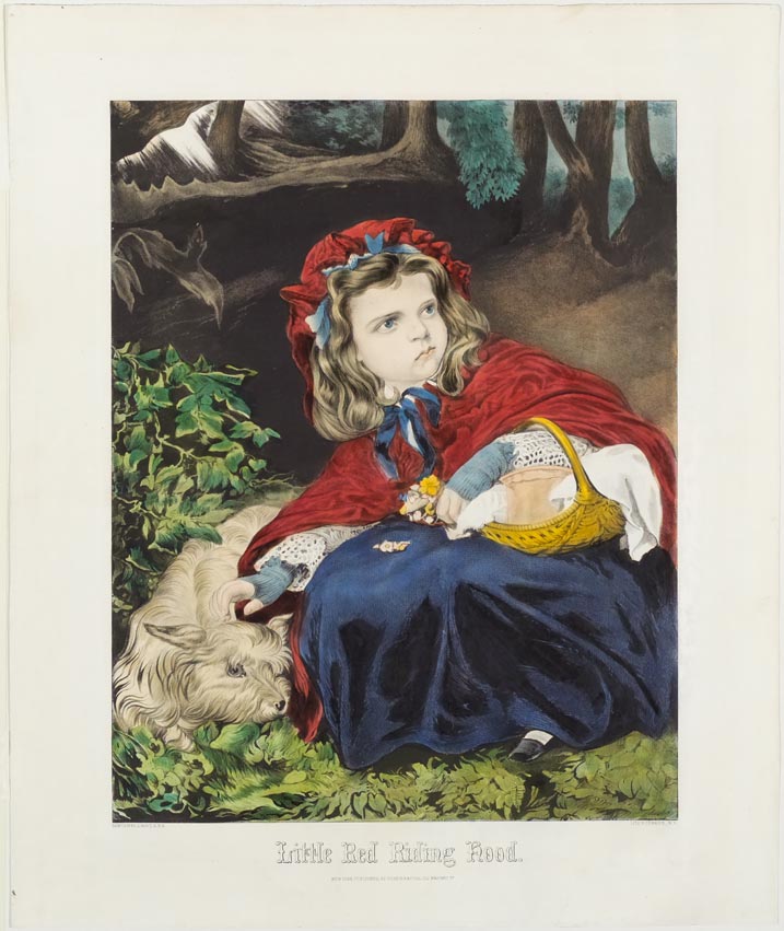 Girl in woods wearing a red hooded cape