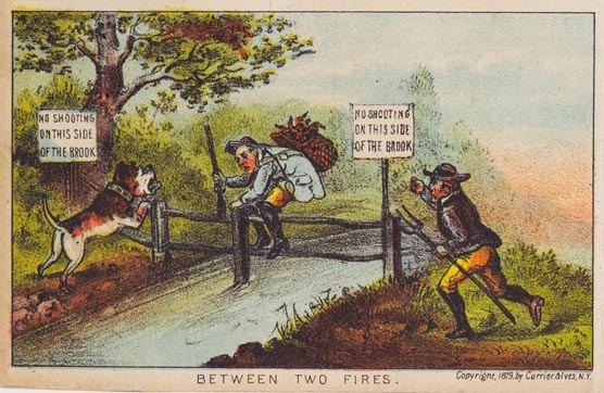 Man with rifle and backpack climbing over fence across stream