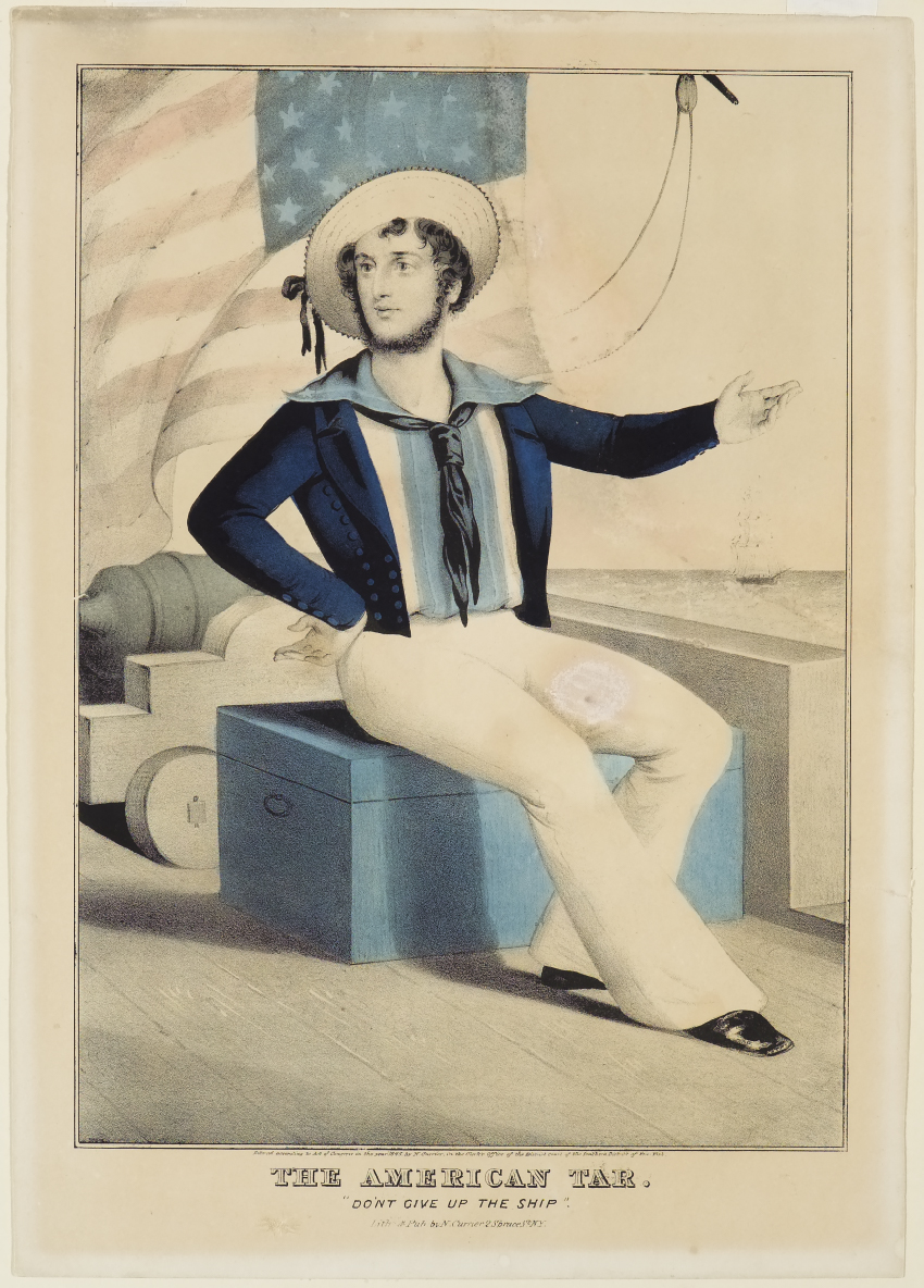 Sailor sitting at center on blue truck while facing to left in image with proper left arm extended out from body