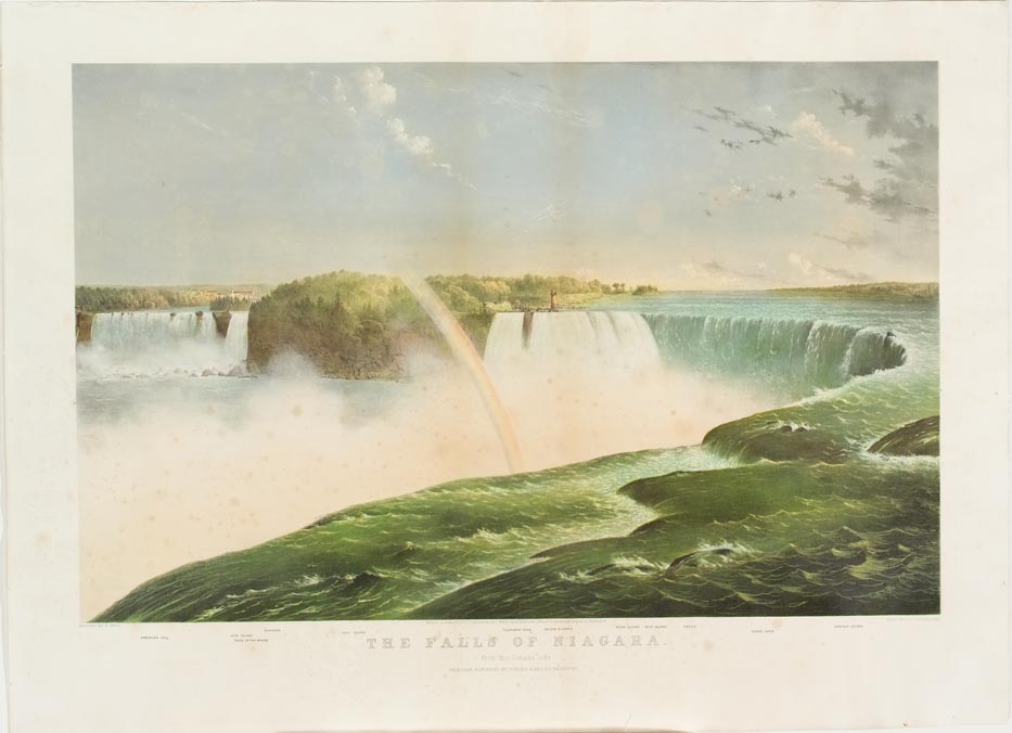 Falls in foreground with rainbow curled to right and down into falls