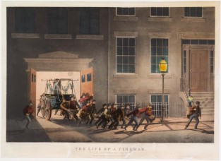 Team of firemen pulling wagon out of building and headed to right down street in image