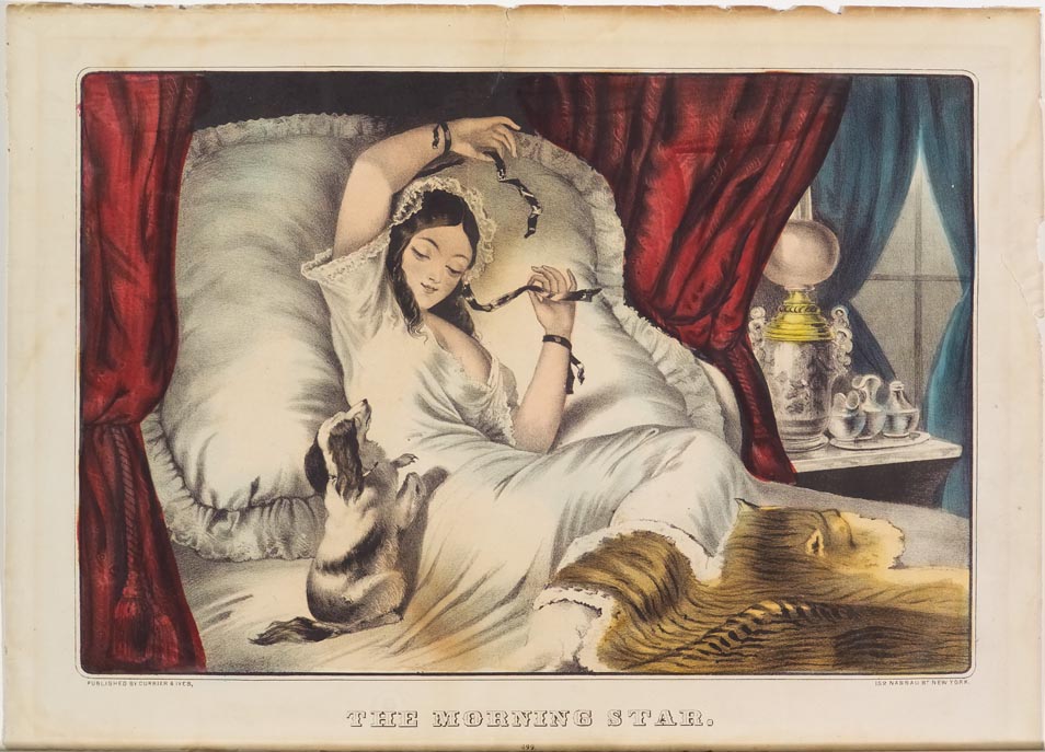 Woman reclining in her bed against pillows wearing a white gown and teasing her dog with ribbon in her hair