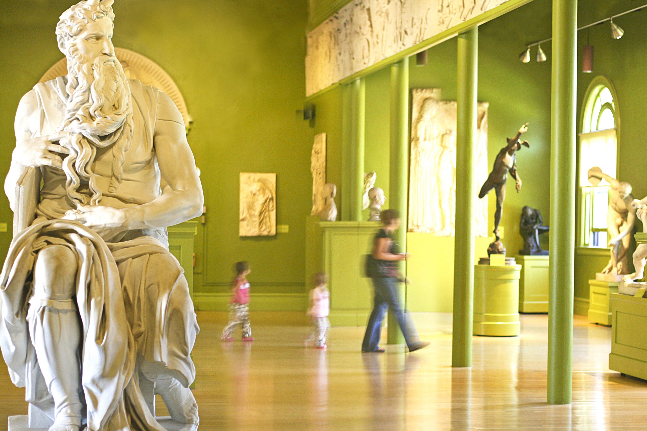 Moses sculpture with family in the background