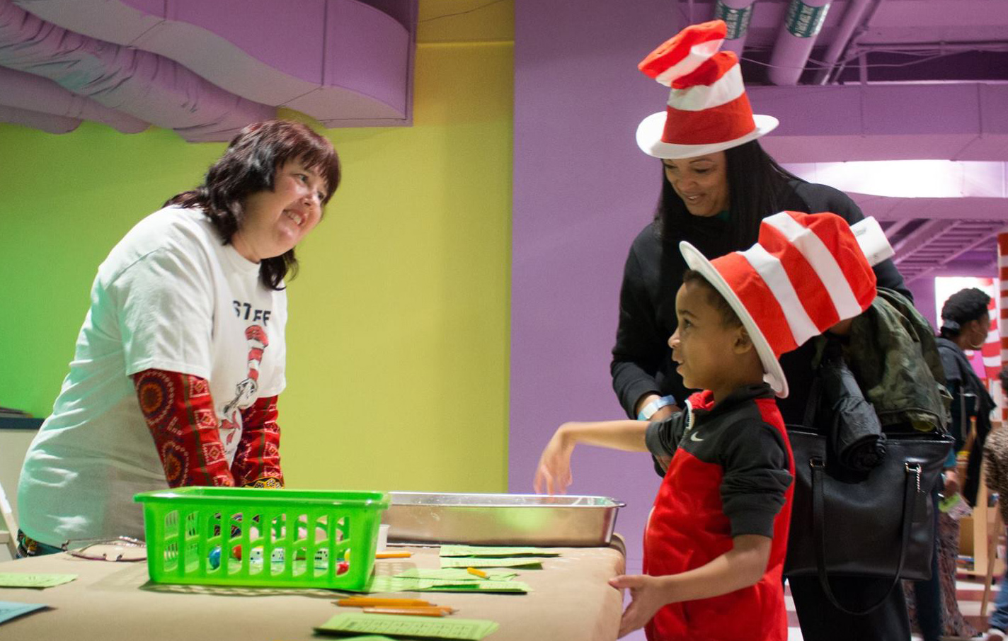 Volunteer assists visitors in the Cat's Corner