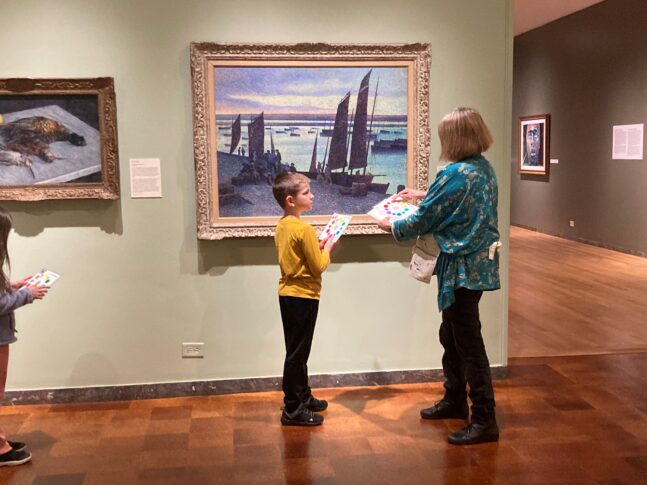 Docent guide and student with impressionist painting