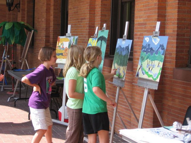 Three young people painting