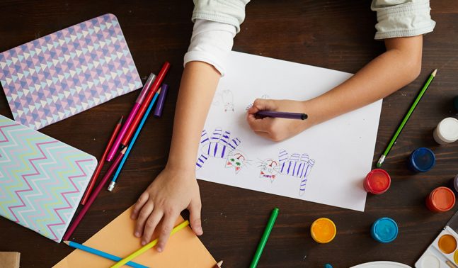 Young person drawing cats