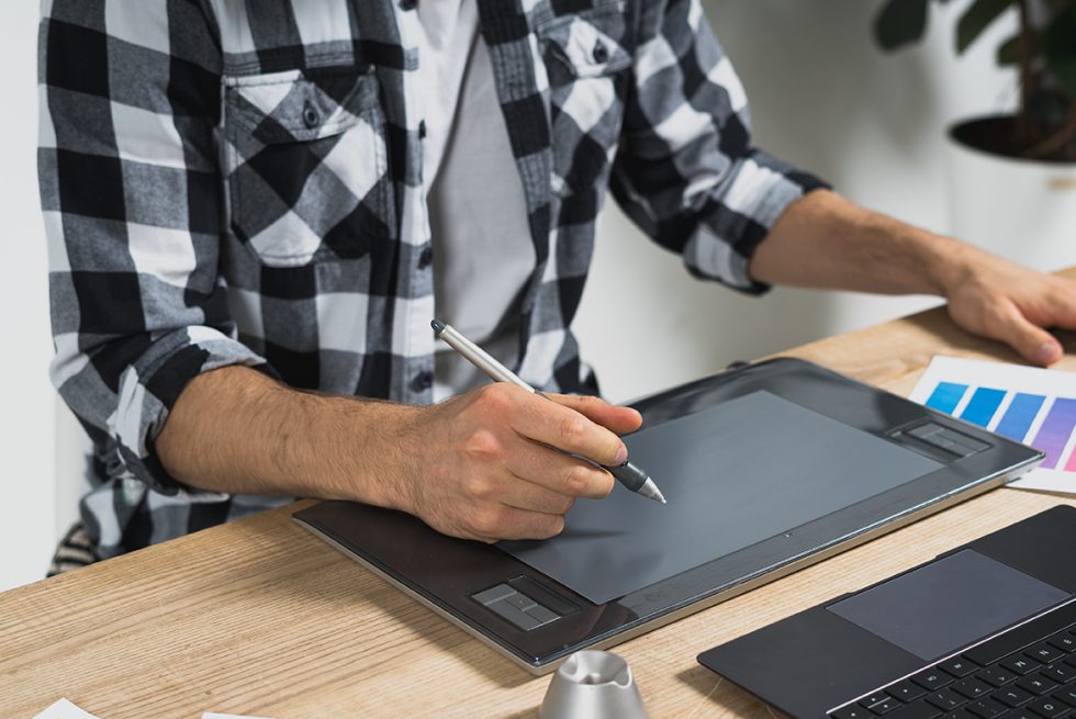 Man using tablet and stylus
