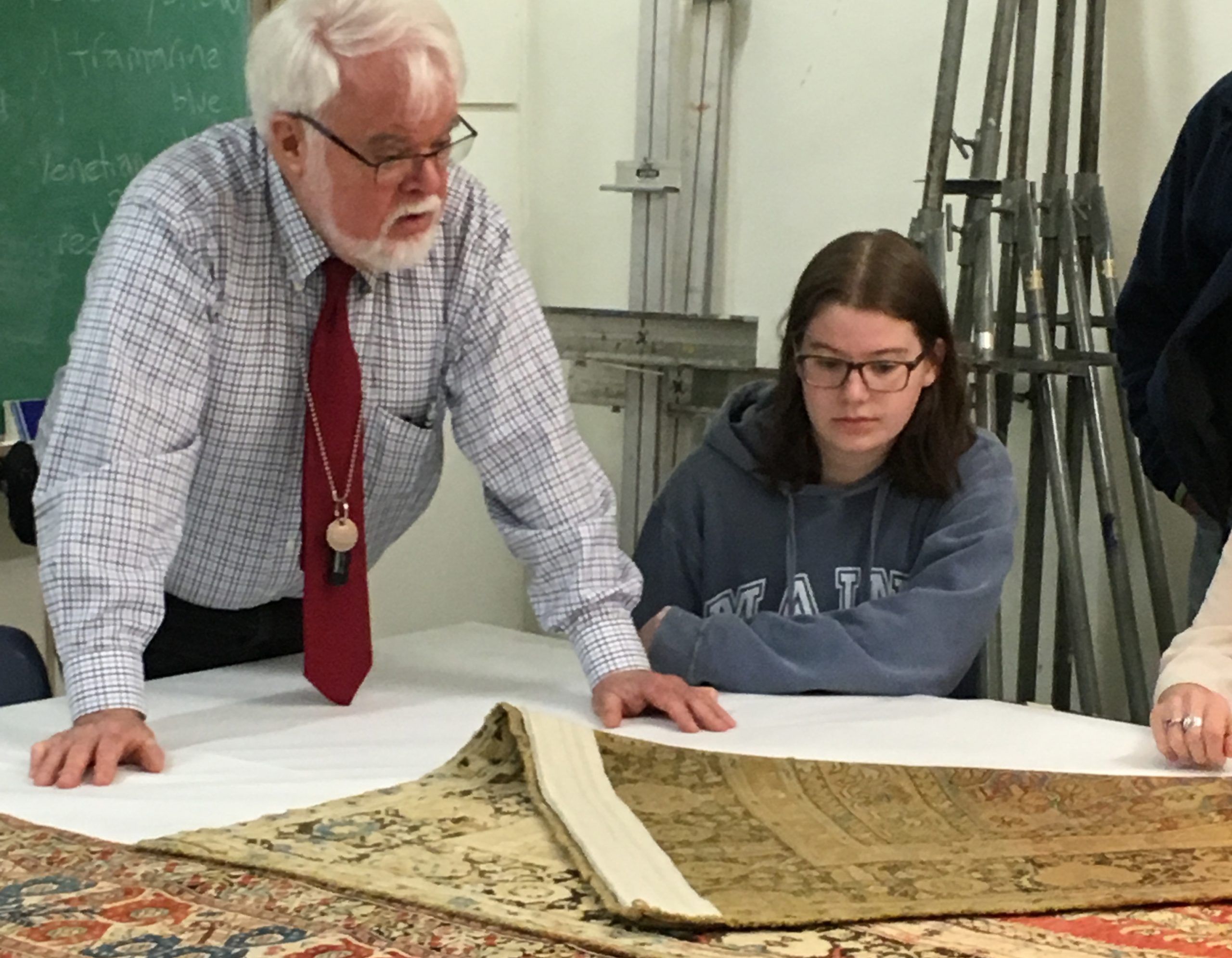 Prof. Walter Denny examines a rug