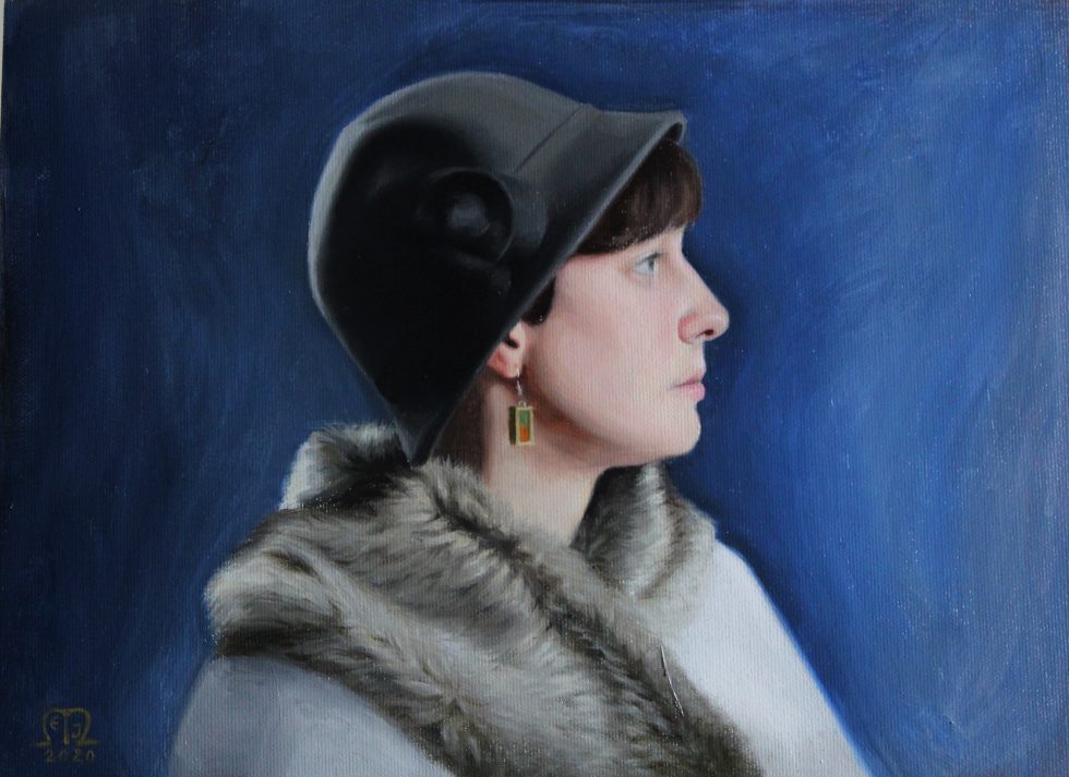 Profile portrait of a woman in a gray cloche hat and fur stole