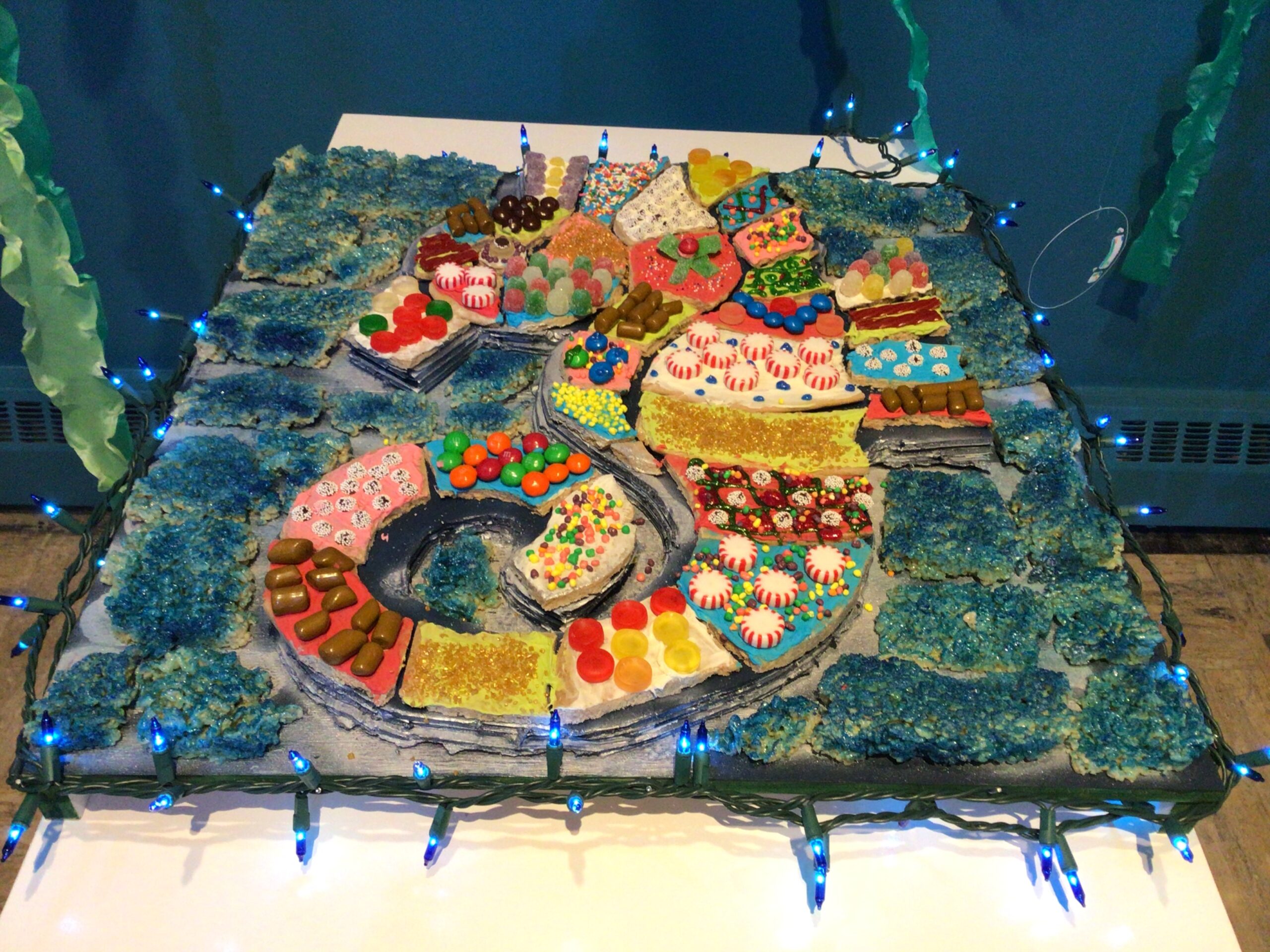 Gingerbread Seahorse with many patches of different candy and frosting to make a patchwork pattern