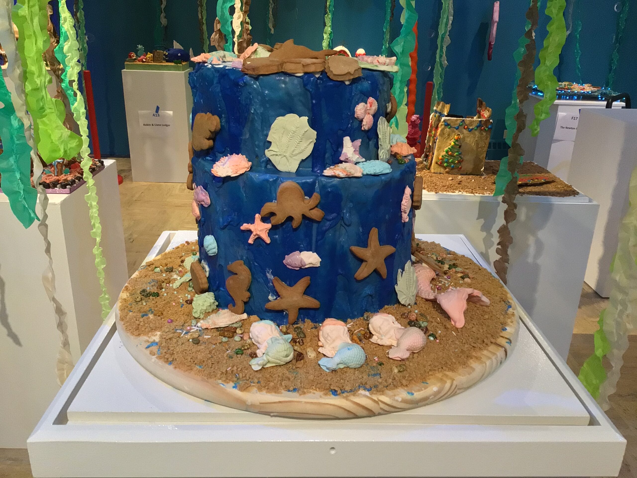 Two tiered round gingerbread with many candy fish