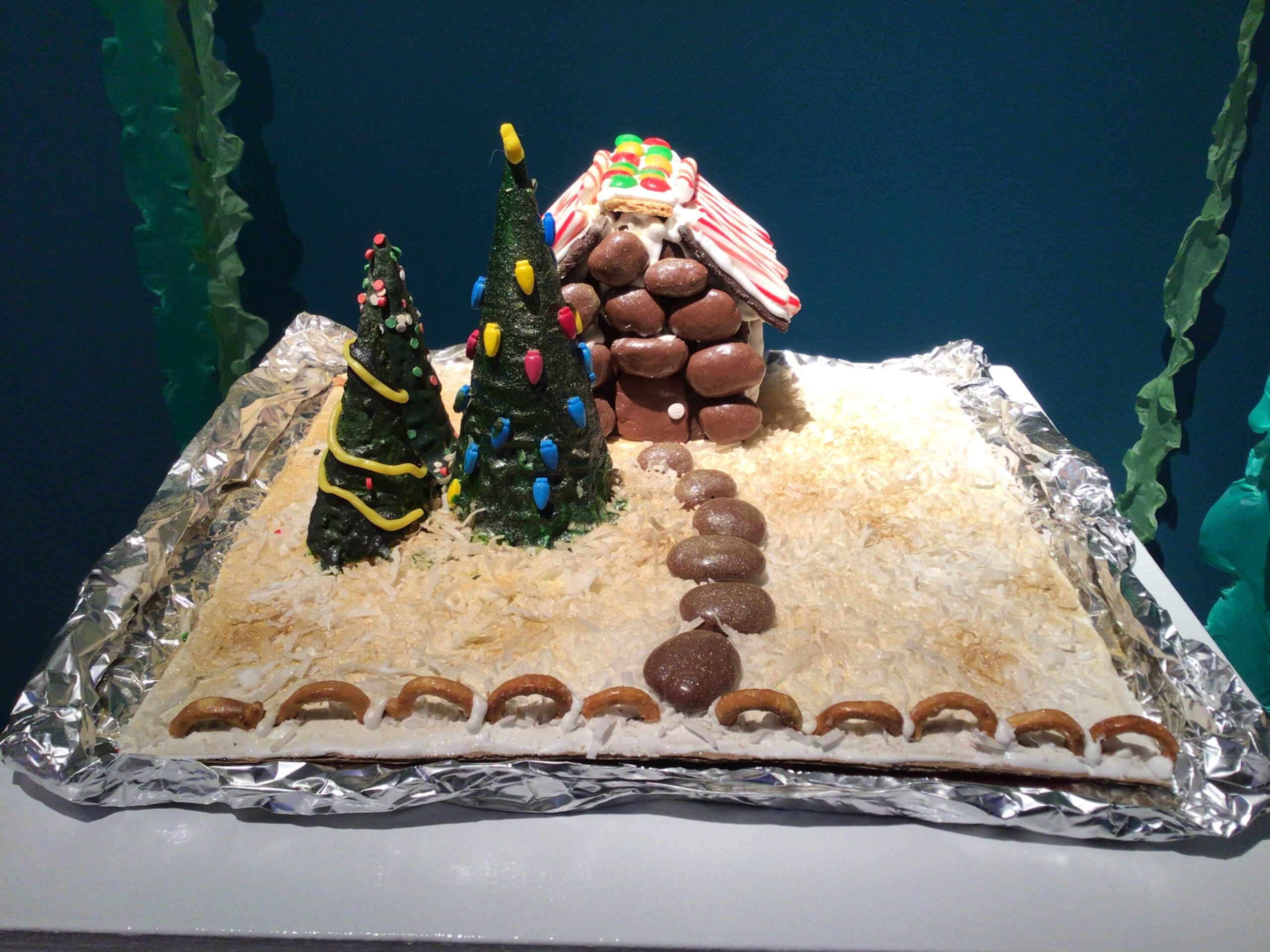 Gingerbread house with three cone trees