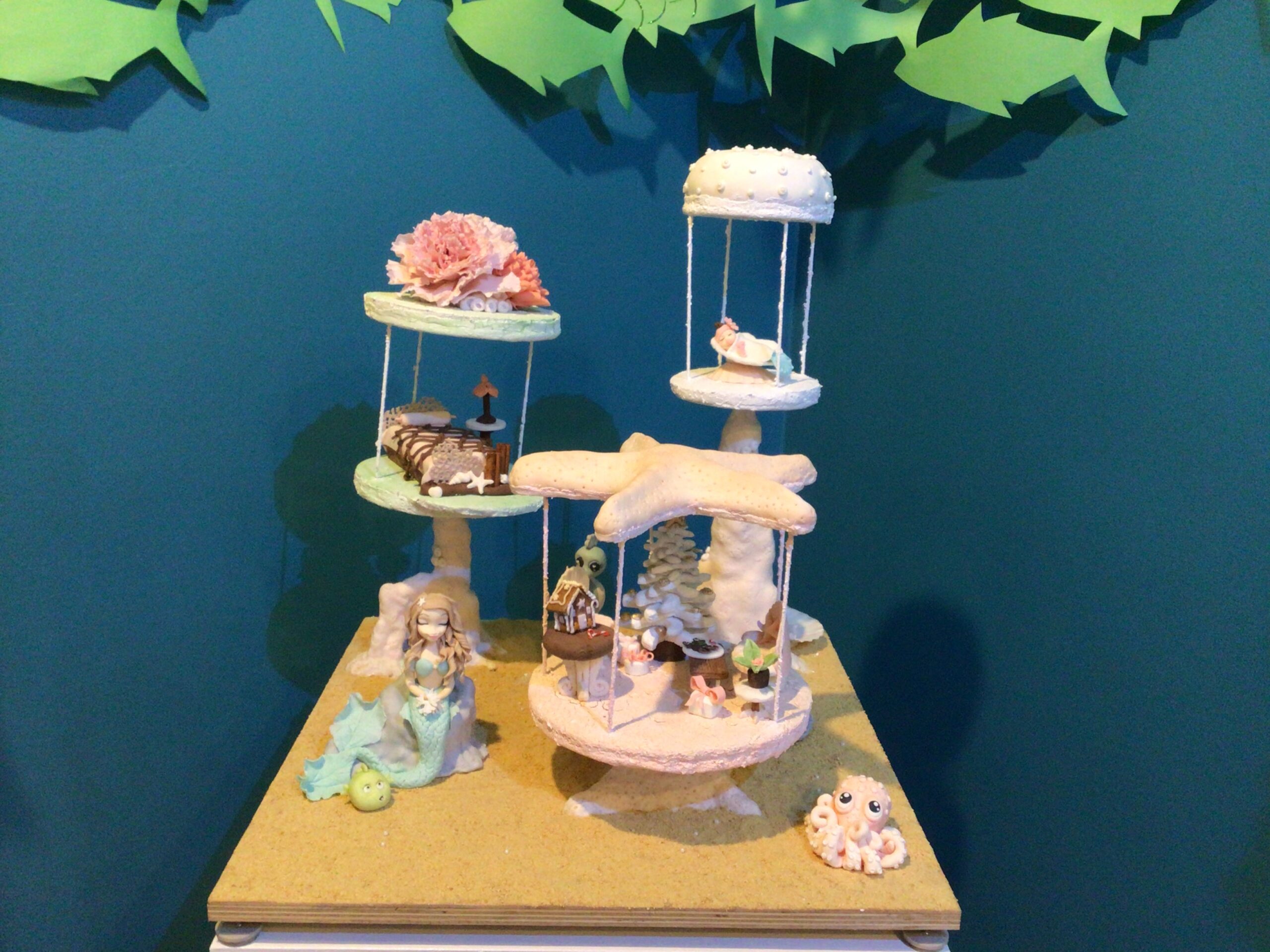 many tiered gingerbread construction with a candy mermaid