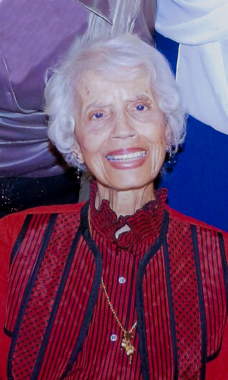 An African American woman in a red and black striped shirt
