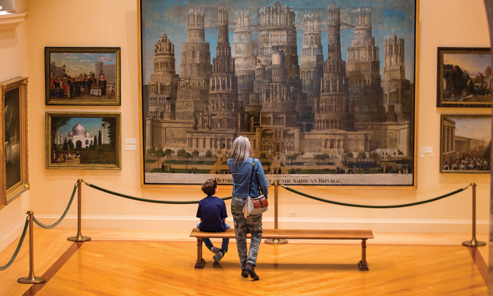 Woman and boy looking at a large painting