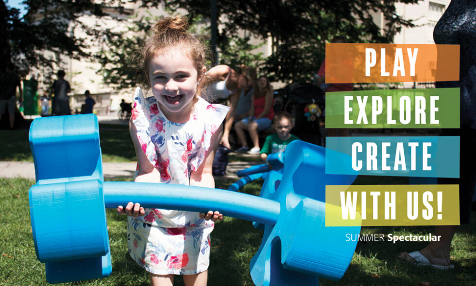 Girl holding large blue foam shapes