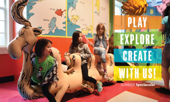 Children seated on a statue of an imaginary creature