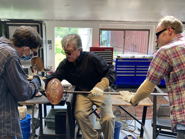 Artists working in a glass studio
