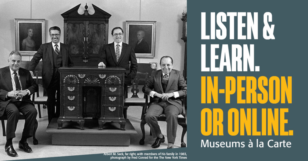 Photo of four men seated around antique furniture