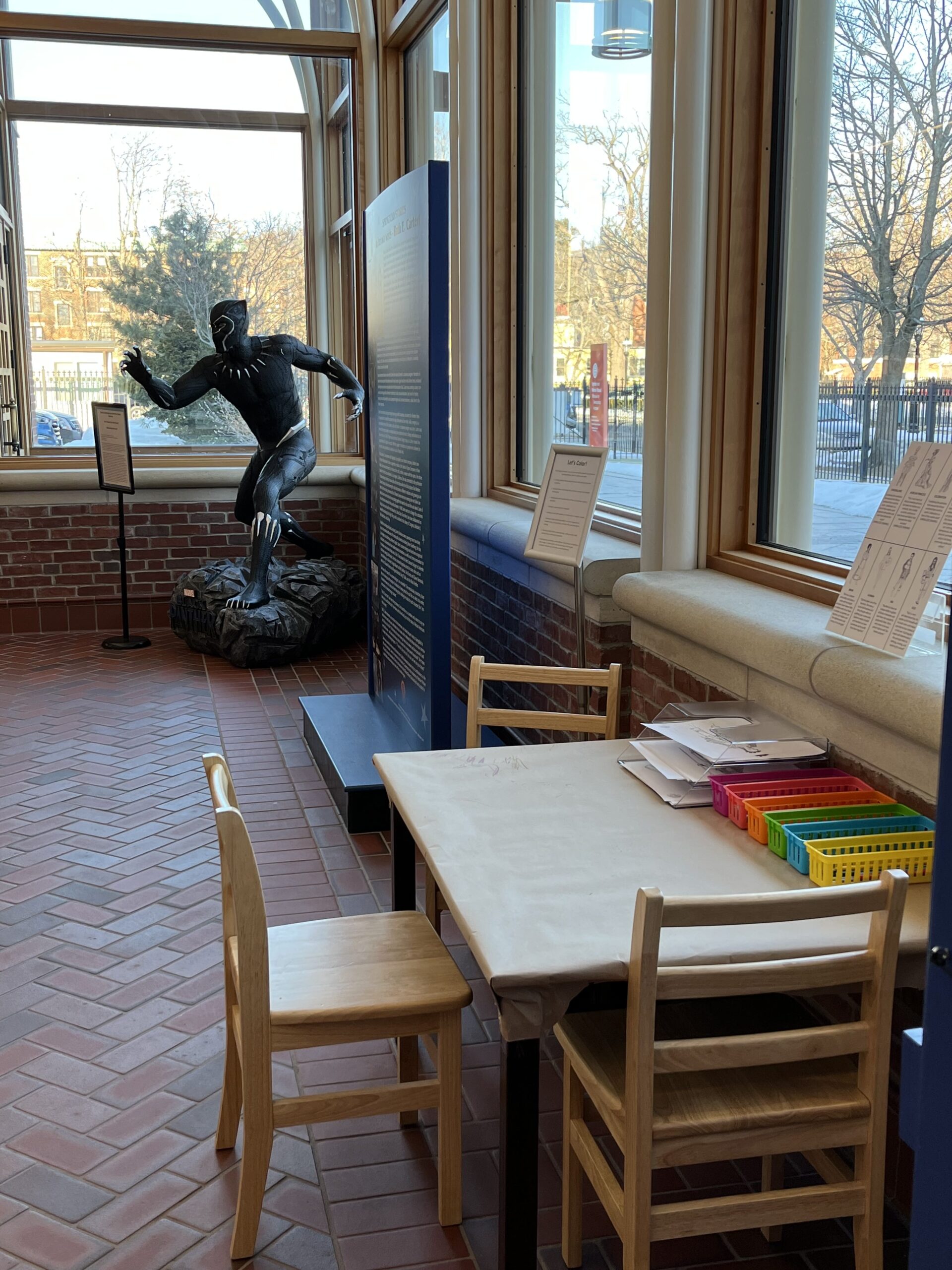 Black Panther statue next to other exhibit tables and stands