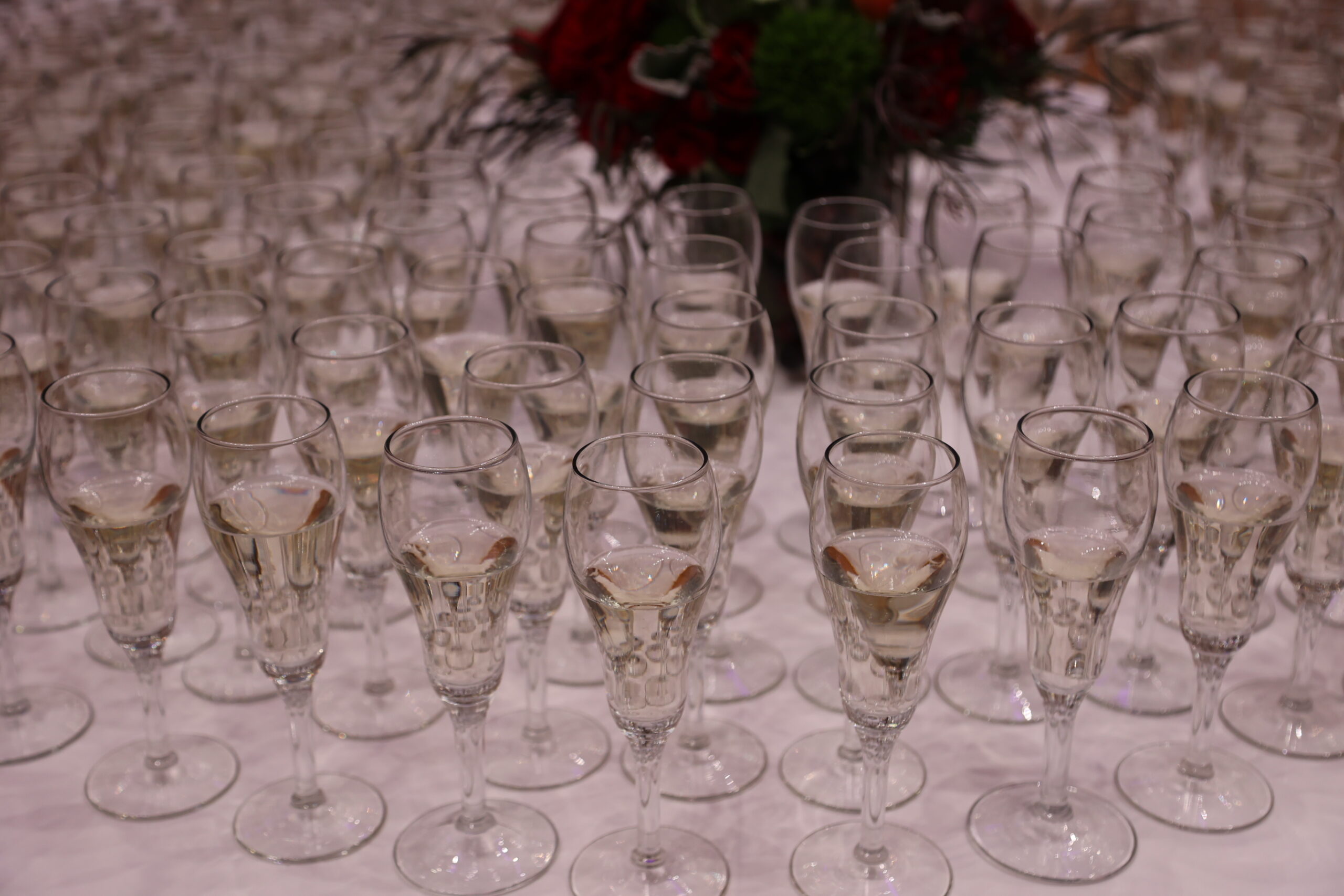 Close up of rows of champagne glasses on a table