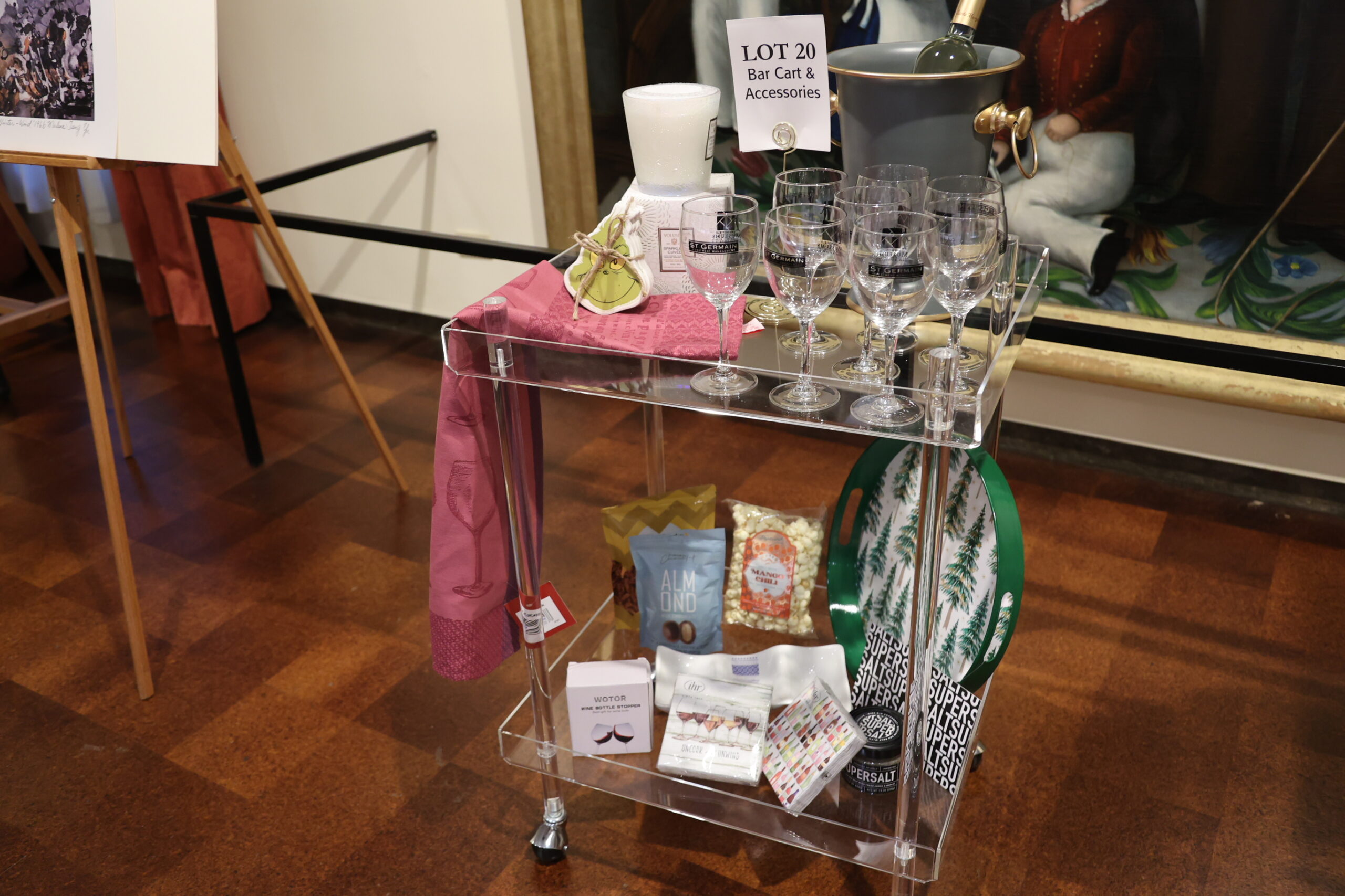 Close up of a bar cart filled with wine and food accessories