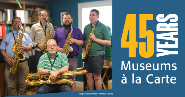 Five men holding saxophones