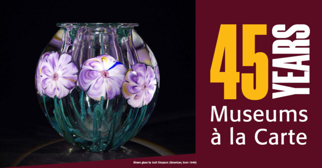 Glass vase with purple floral insets.
