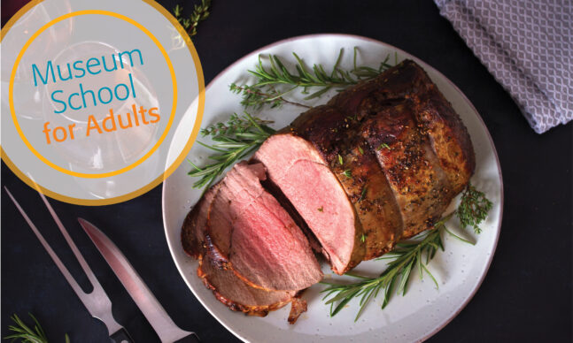 Sliced roast beef with herbs and red wine on dark background.