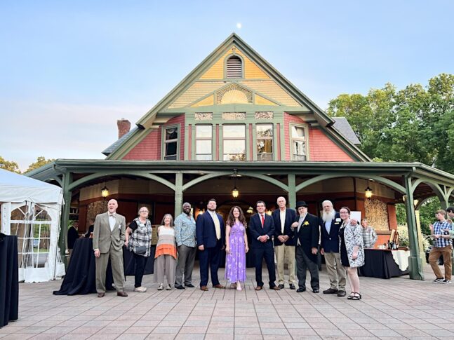 Members of the Sprignfield Preservation Trust stand out side a historic building
