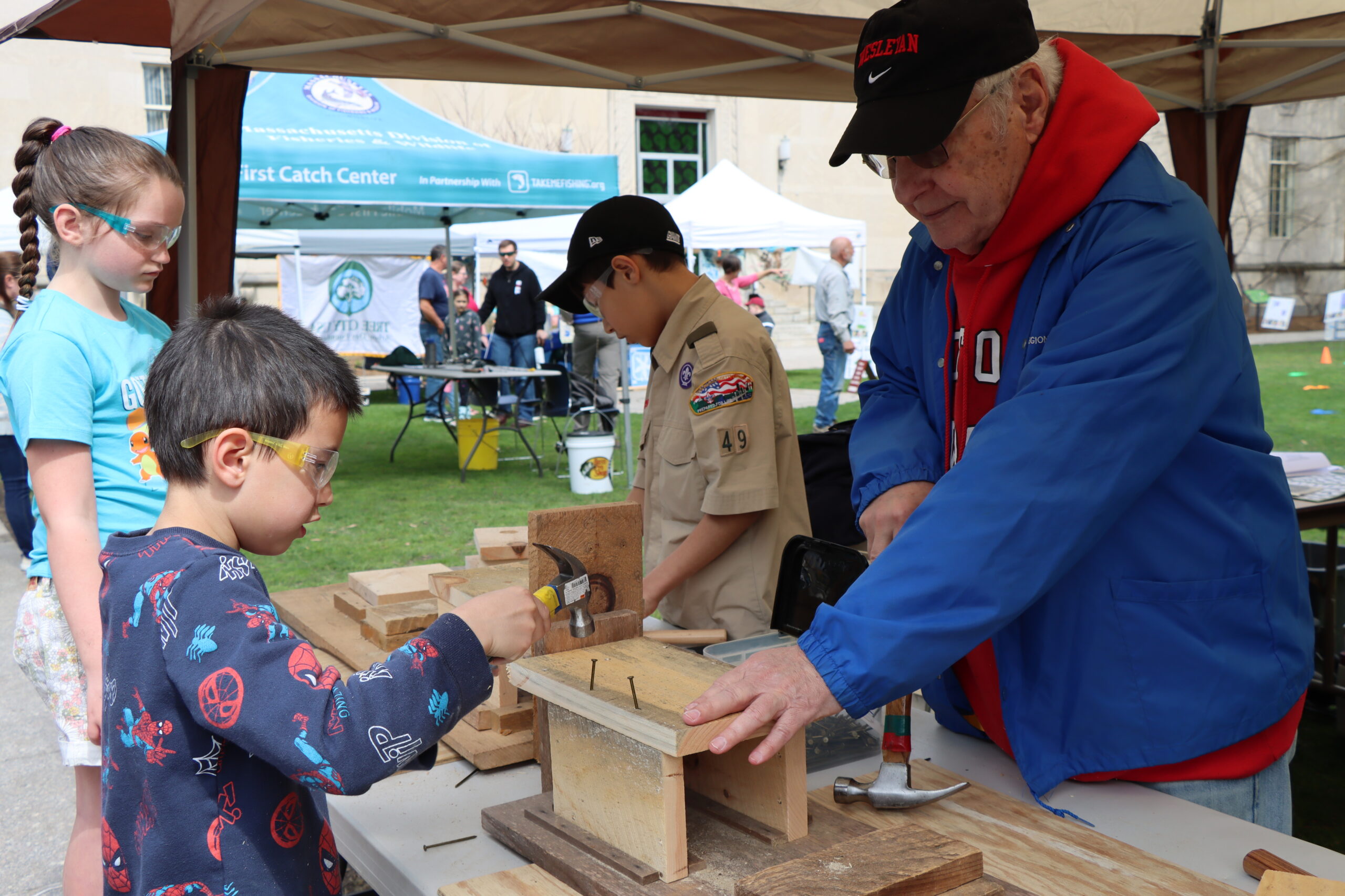 Man teaches boy build bird house