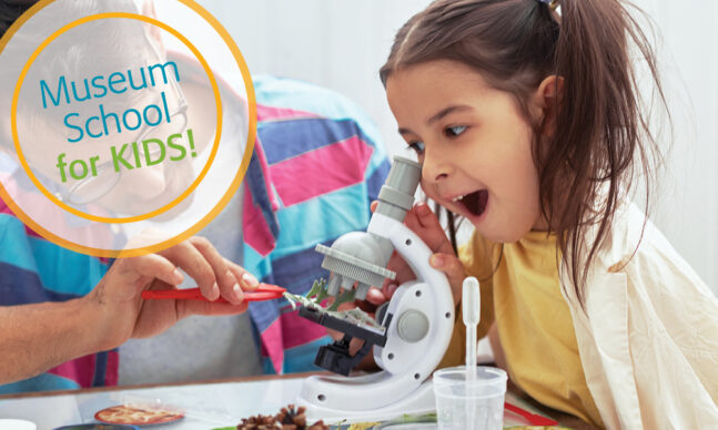 Girl looking trough the microscope