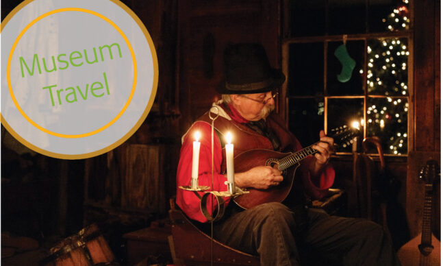 Man playing guitar by candlelight