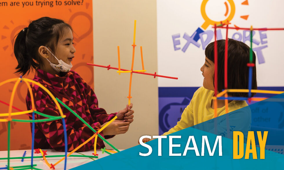 Two girls build structures with tinker toys