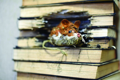 small sculpture of a mouse made from pages of old books.