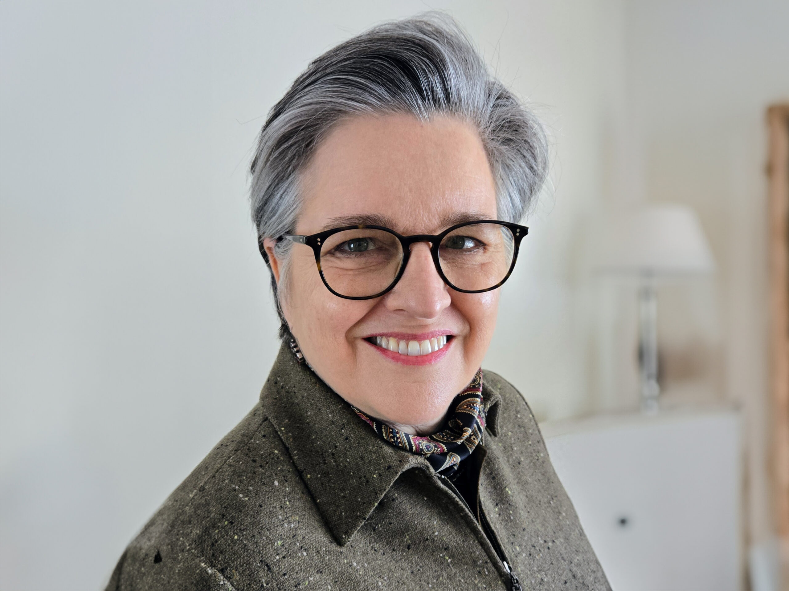 Woman with short hair and glasses