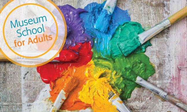 Paint brushes arranged in a circle with rainbow paints.